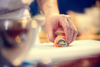 Cropped image of chef preparing sushi in restaurant