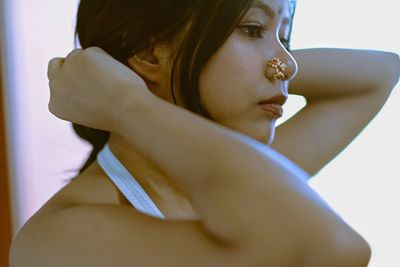 Close-up portrait of young woman looking away