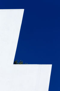 Low angle view of built structure against clear blue sky