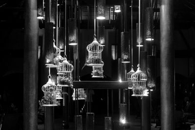 Illuminated statue hanging at night