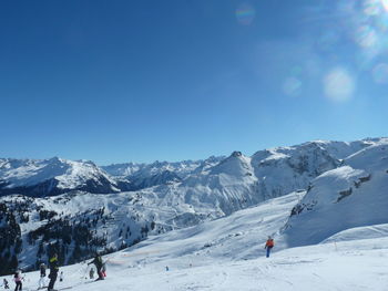 People skiing on snow covered mountain