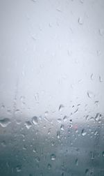 Full frame shot of raindrops on glass window