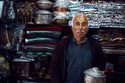 Portrait of mature man standing at market