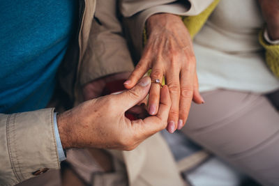 Midsection of senior man wearing ring outdoors