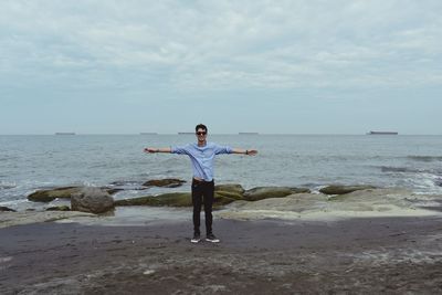 Full length of man standing on beach