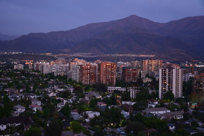 High angle view of buildings in city at night