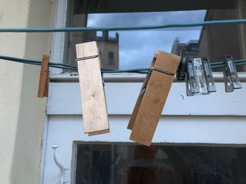 Low angle view of clothes hanging on clothesline against window