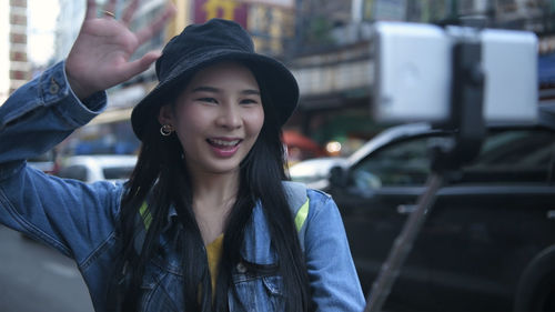 Portrait of smiling young woman in car