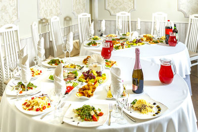 Laid banquet table with snacks and fruits and champagne. horizontal photo