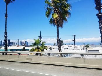 View of city street against blue sky