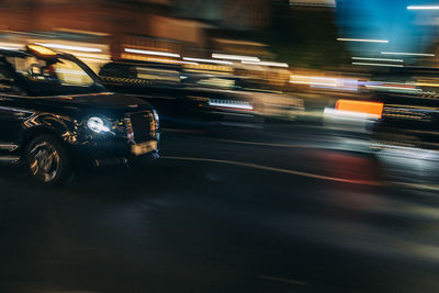 Uk, england, london, blurred motion of driving taxi and surrounding traffic at night