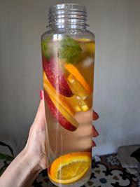 Close-up of hand holding glass of drink