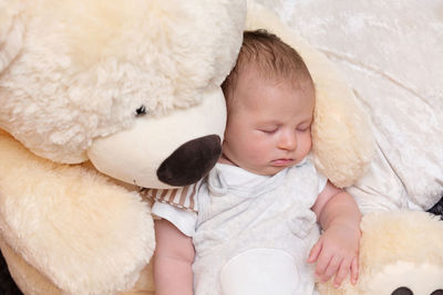 Cute baby girl sleeping on bed