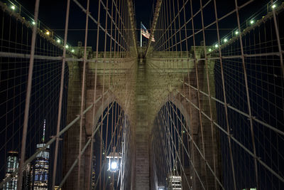Low angle view of suspension bridge at night