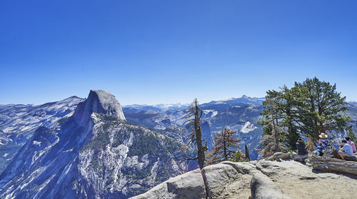 Scenic view of snowcapped mountains against clear blue sky