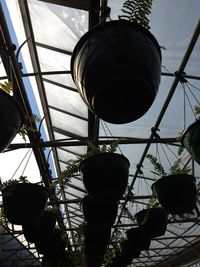 Low angle view of lighting equipment hanging against sky