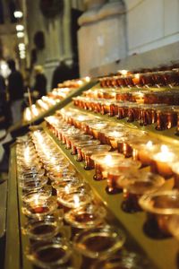 Close-up of illuminated candles in temple