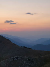 Scenic view of silhouette mountains against sky during sunset