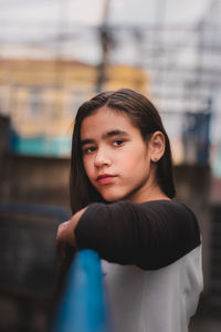 Portrait of girl leaning on railing outdoors