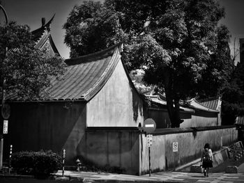 Rear view of people walking outside building