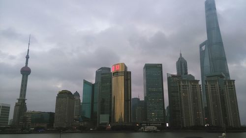 Buildings against cloudy sky