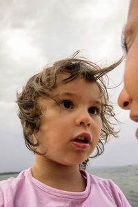 Cropped image of woman with worried daughter on shore