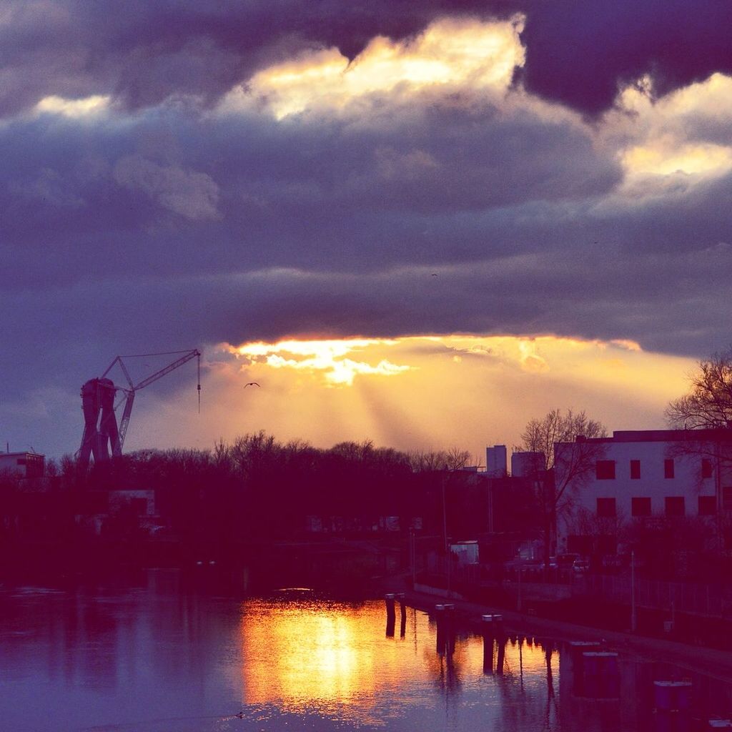 sunset, water, sky, reflection, waterfront, built structure, architecture, sun, river, cloud - sky, building exterior, orange color, connection, sunlight, beauty in nature, scenics, silhouette, lake, nature, cloud