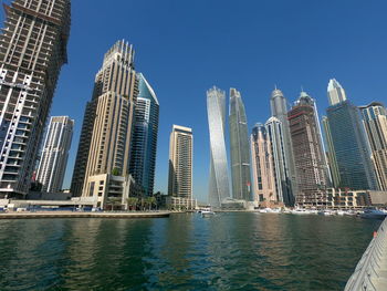 Modern buildings in city against clear sky