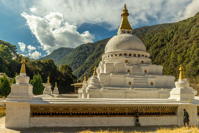 Panoramic view of building and mountains against sky