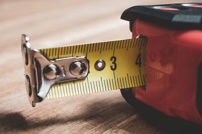 High angle view of tape measure on wooden table