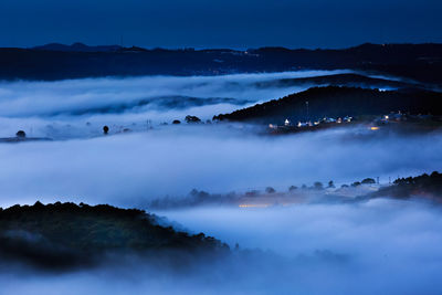 Scenic view of mountains against sky at night