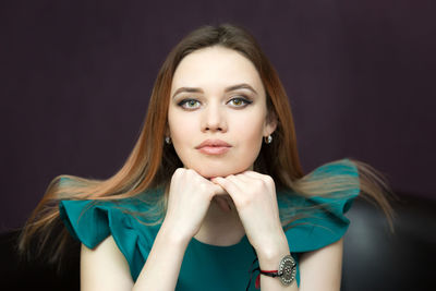 Portrait of a beautiful young woman over black background