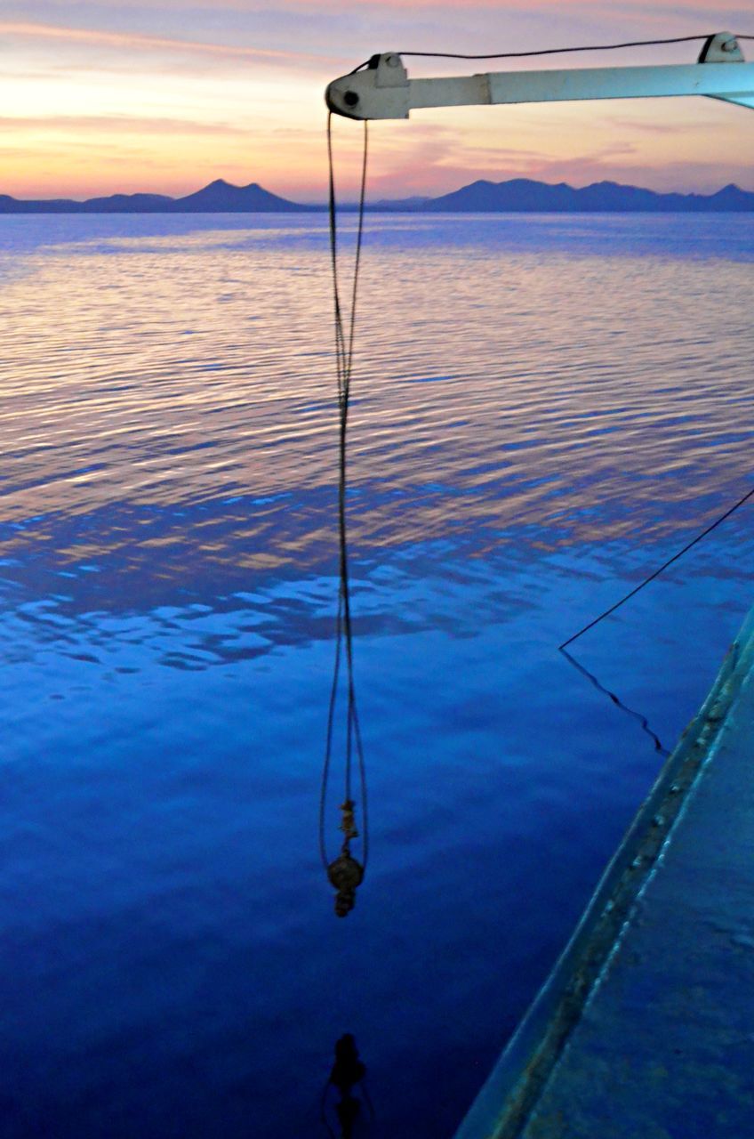 BOAT IN SEA AGAINST SKY AT SUNSET