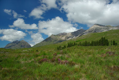 Scenic view of mountains against cloudy sky