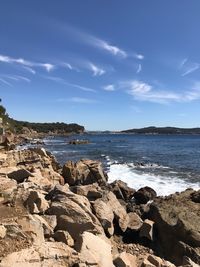 Scenic view of rocks on beach against sky