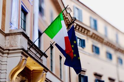 Low angle view of flags hanging on building