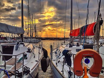 Boats in harbor at sunset