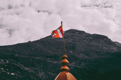 Rear view of flag on mountain against sky