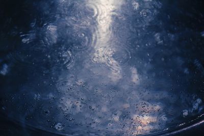 Full frame shot of raindrops on water