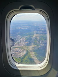 Aerial view of cityscape seen through airplane window