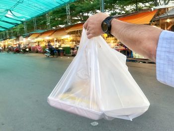 Midsection of man holding ice cream