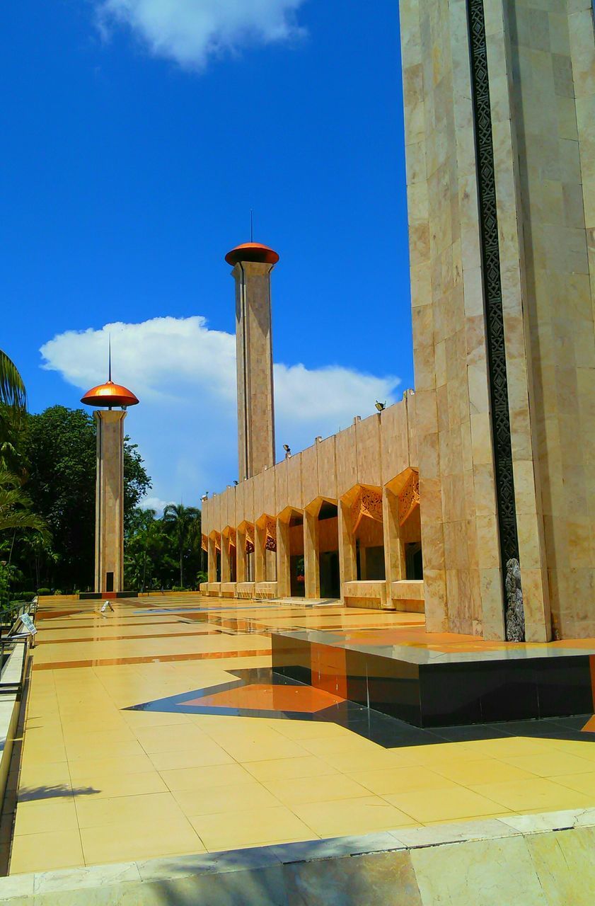 architecture, built structure, building exterior, blue, sky, low angle view, street light, sunlight, clear sky, tree, shadow, day, outdoors, building, architectural column, place of worship, exterior, no people, tower, religion