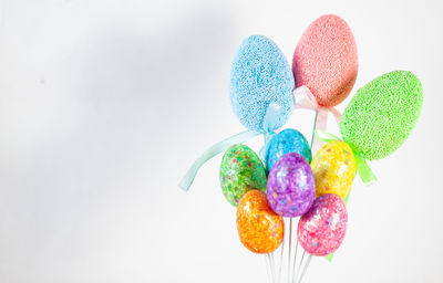 Close-up of multi colored candies against white background