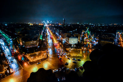 High angle view of city lit up at night