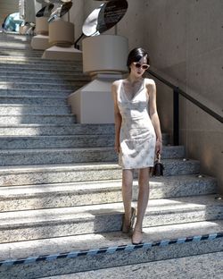 Portrait of young woman sitting on steps