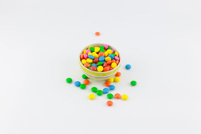 Multi colored candies against white background