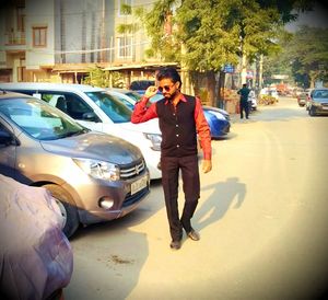 Man standing on street in city