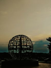 Silhouette ferris wheel against sky at sunset