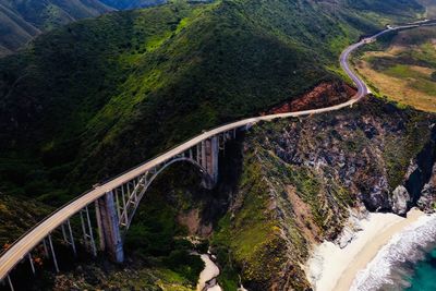 Aerial view of bixby creek bridge by mountain