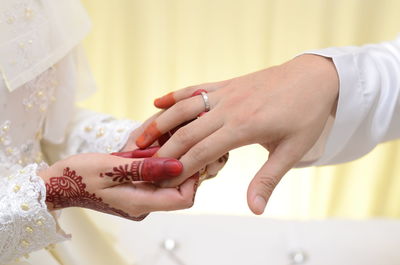 Close-up of couple holding hands